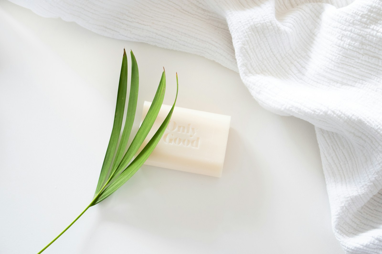 white textile with green leaves